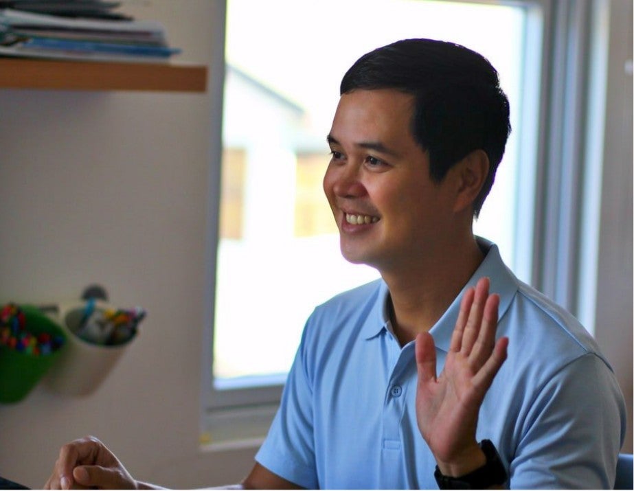 Man waving to computer screen