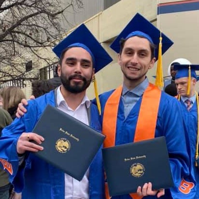 two male students in graduation robes