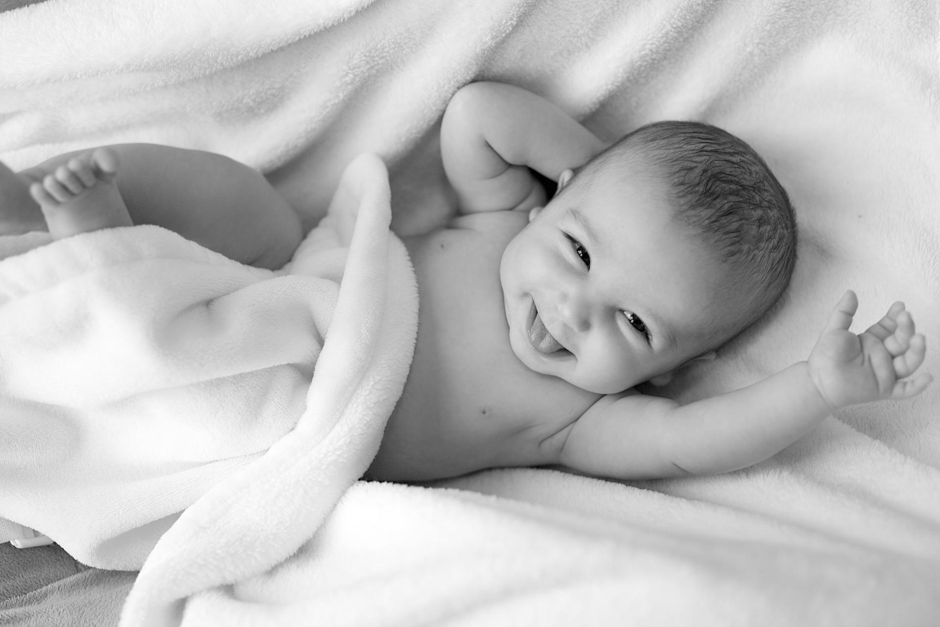 baby laying on a blanket