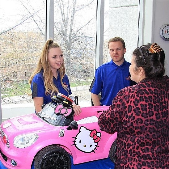 Students greet visitors at a Bronco Day event
