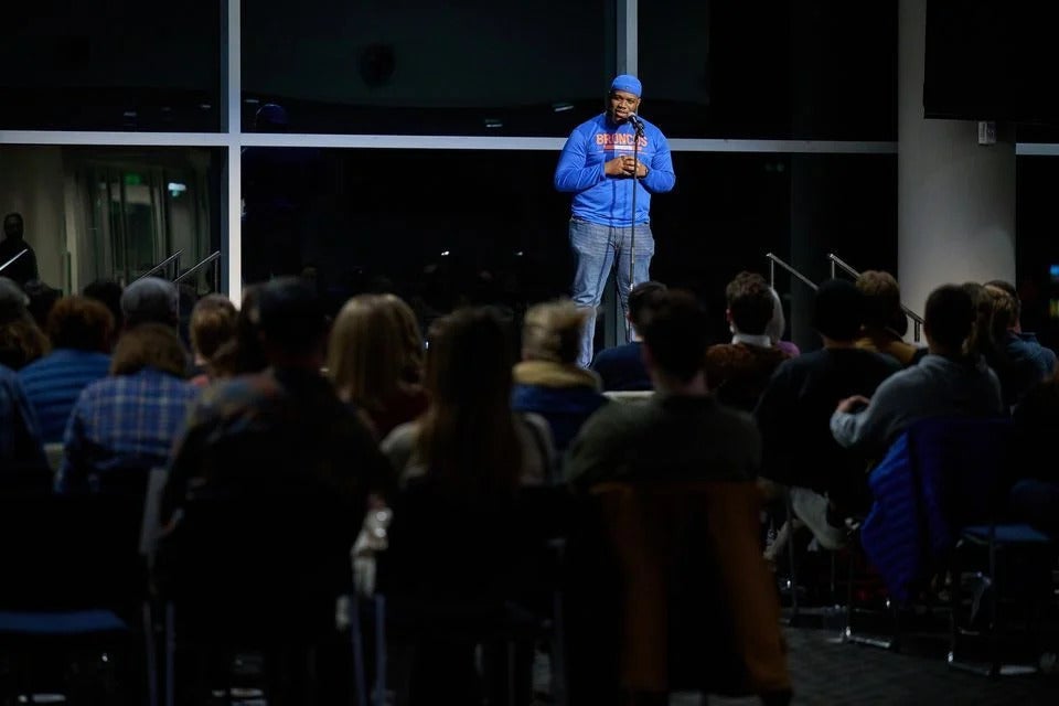male student presenting on stage