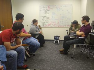 photo of Astro robot, visitor, and group memebrs