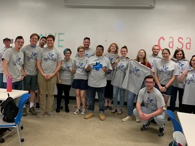 A group of many students at engineering plus camp wearing similar t-shirts