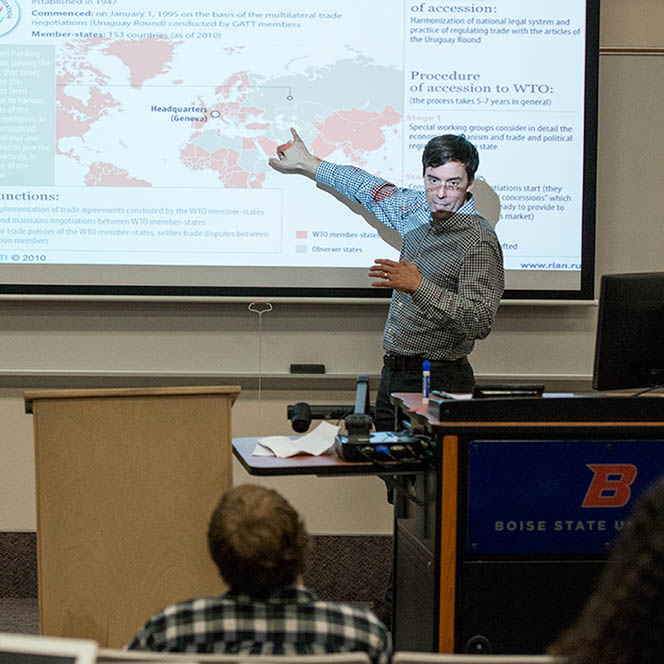 Isaac Castellano points to a screen in a classroom