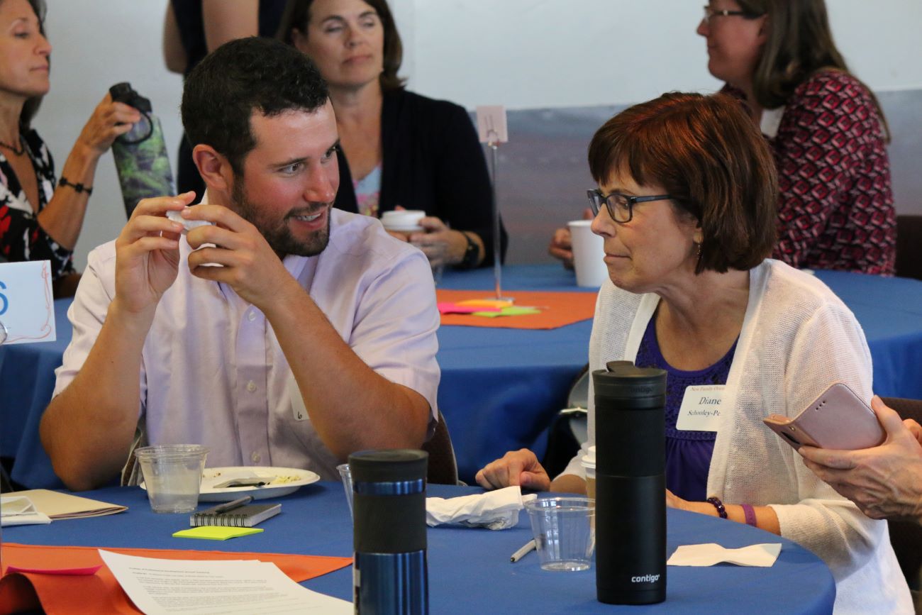 Man and woman talk at table