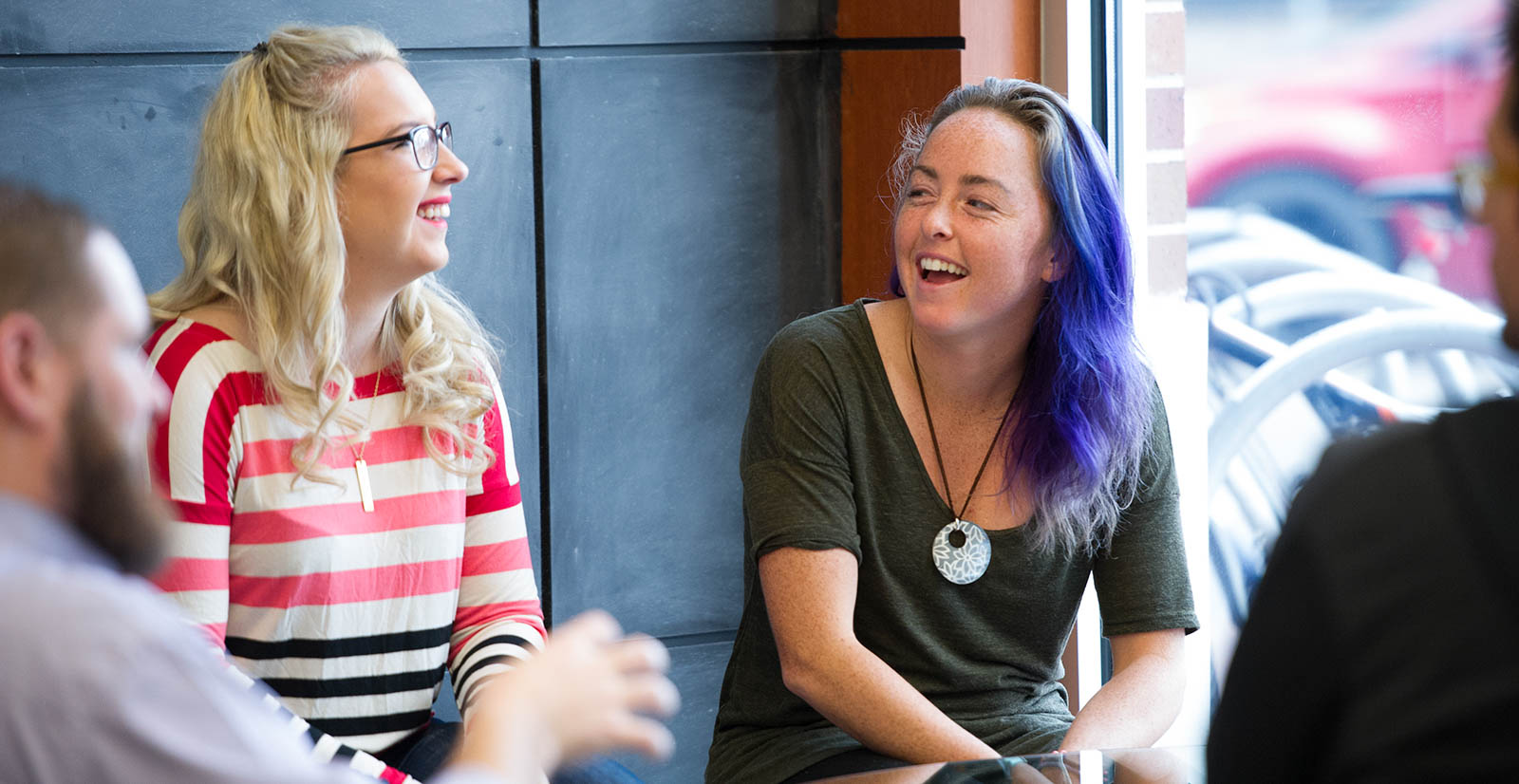Two students laugh with each other