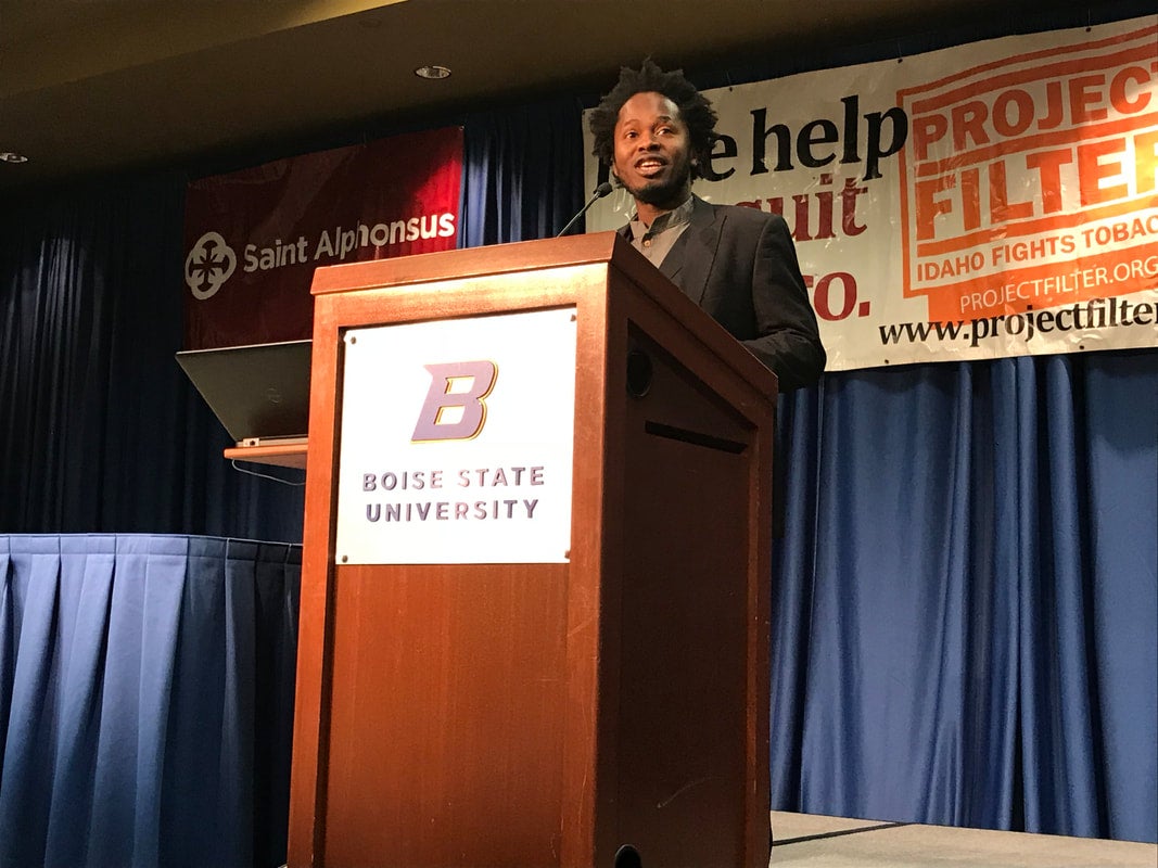 Speaker presents behind podium on stage