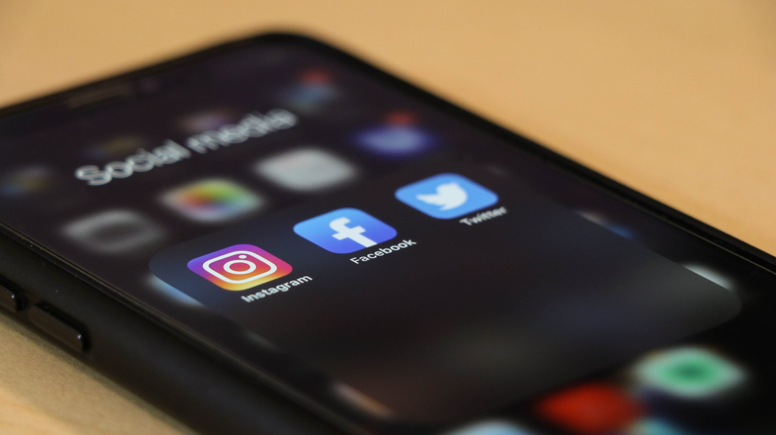 Image of a phone lit up with social media apps