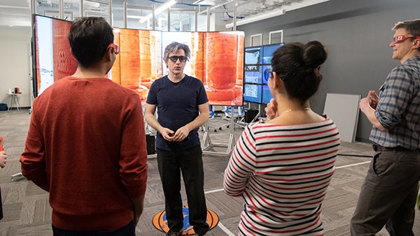 boise state faculty member giving demonstration to three other people