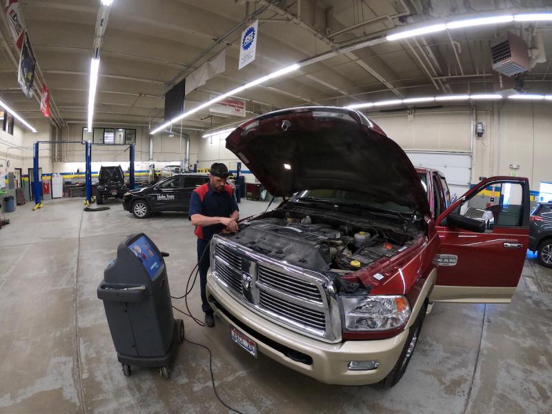 Brock Gunter working on a truck in an autoshop