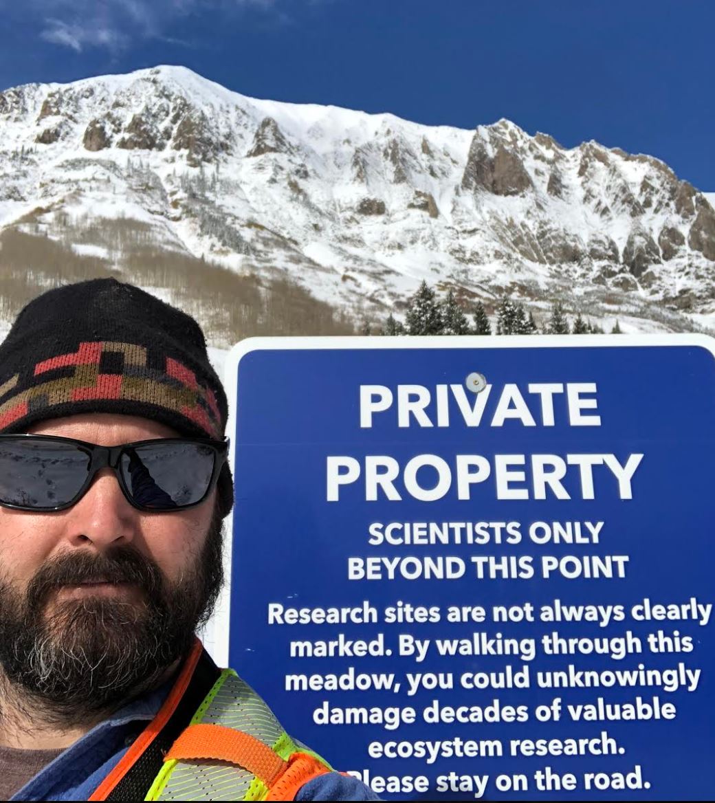 Photo of Thomas Otheim with a Private property board and snow covered mountain in the background