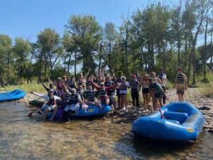group getting into rafts near water