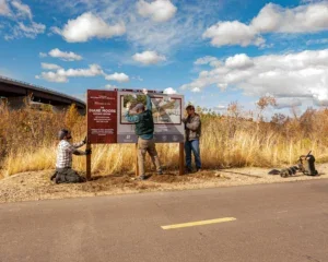 Crew installing a sign along the road