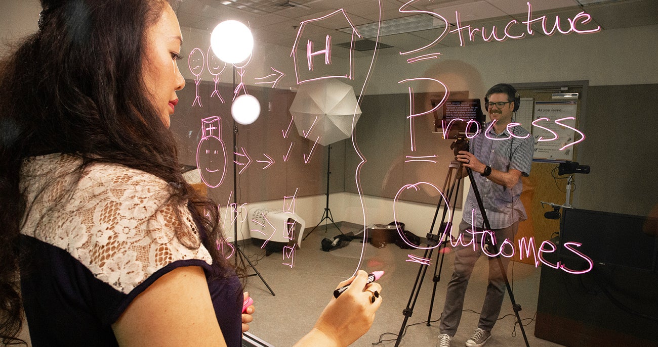 Palina Louangketh works with Tyler Winchester and Lane Donavan to record content for an online class.