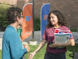 student talks with professor at event