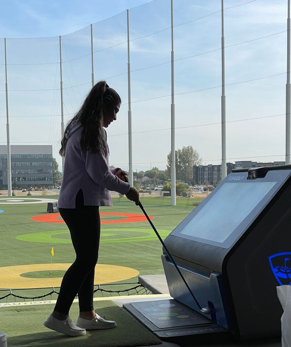 student at Top Golf