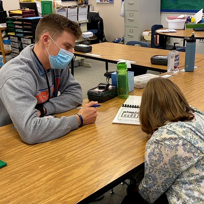 Michael Crawford instructing a student in a classroom