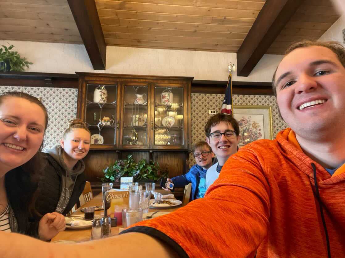 PEERS students at at a restaurant table posing for a photo