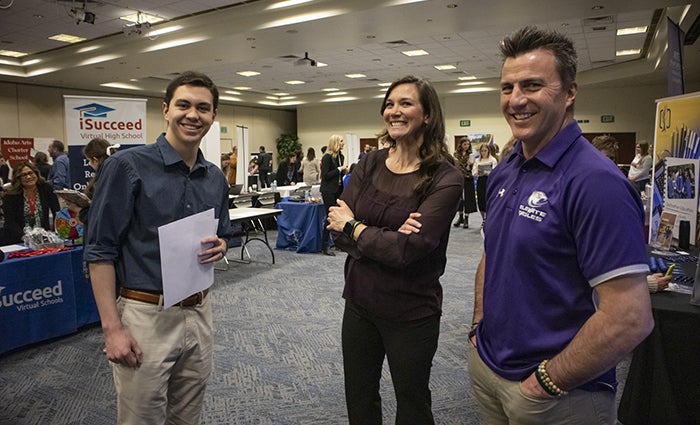 Student with district representatives at the teacher education career fair