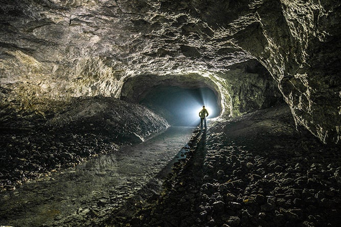 Person standing in underground mine cave