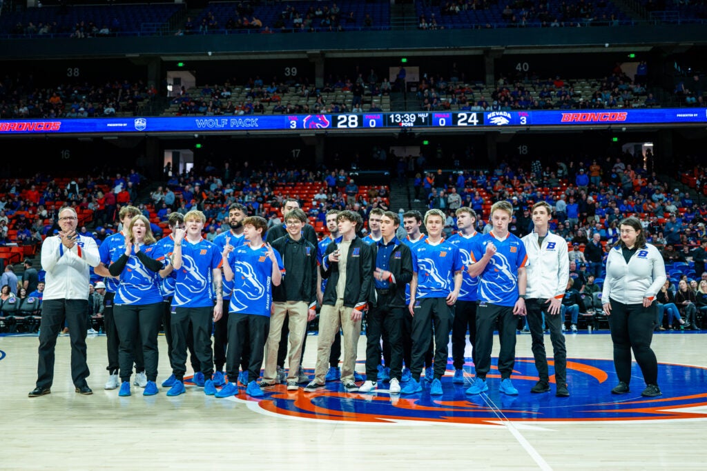 The Boise State Esports program members stand in Extra Mile Arena to receive championship rings.
