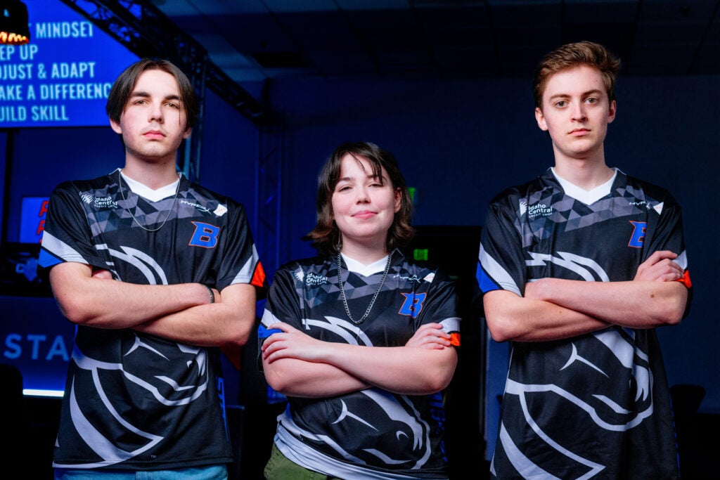 Three Esports team members in their Bronco jerseys posing with their arms crossed.