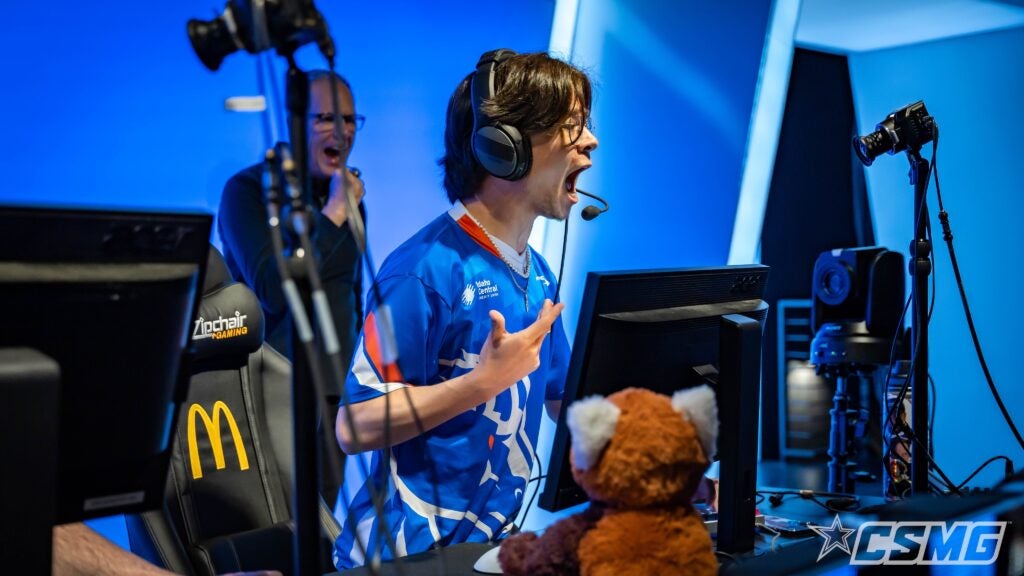 student wearing headset, playing a game in the sports arena