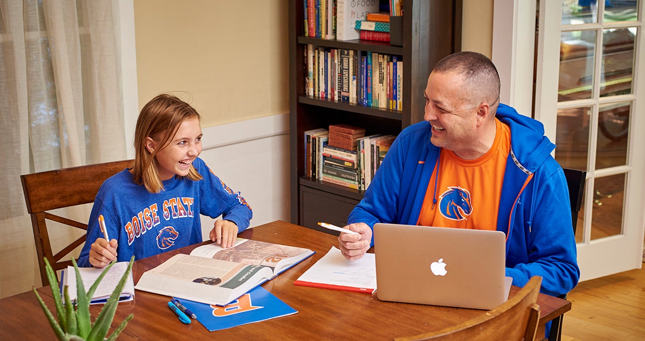 Adult student studies with their child 
