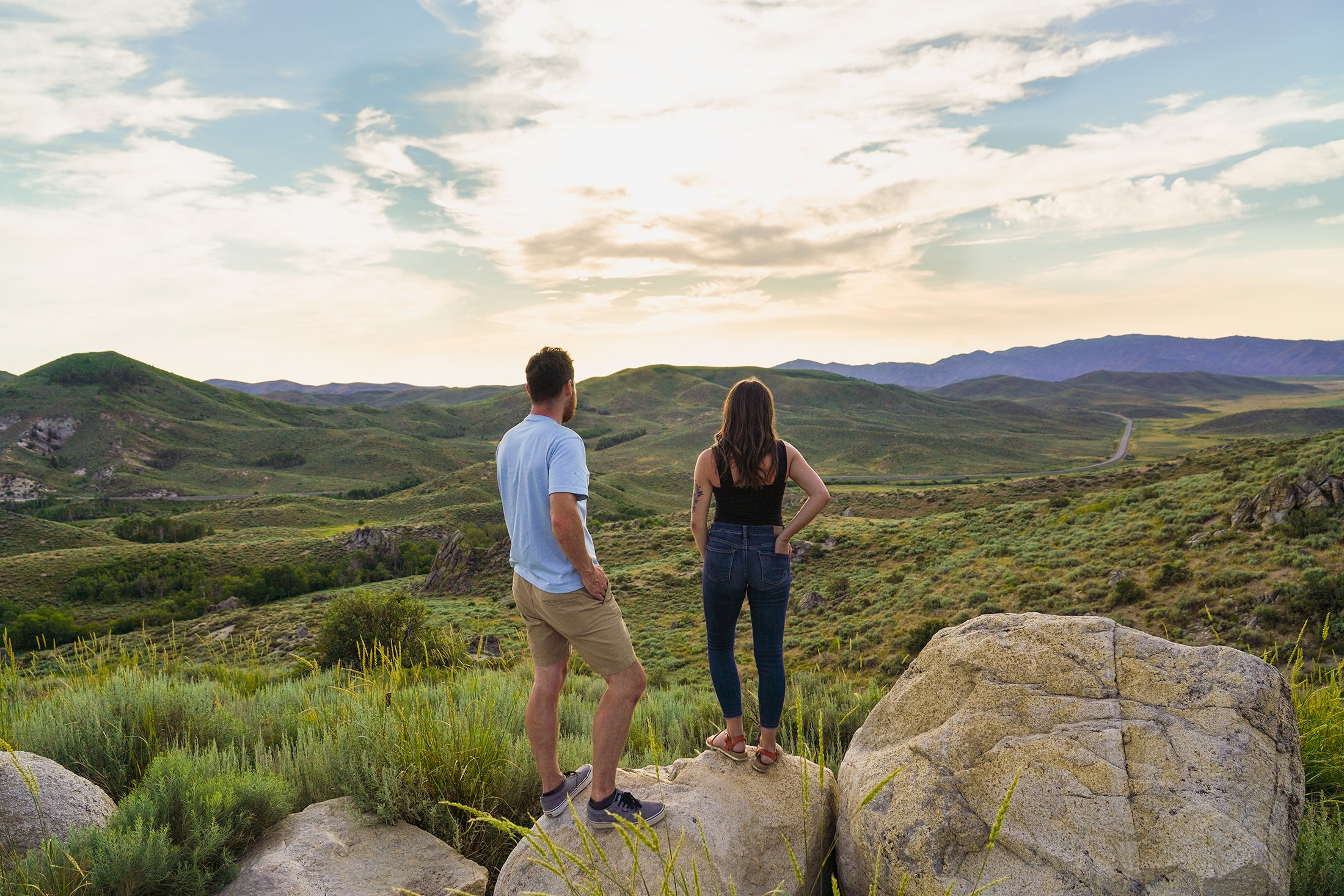 Two students look into a distant sunset