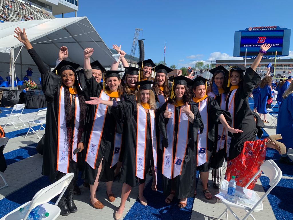 Master of Science in genetic engineering students celebrating graduation in albertson stadium