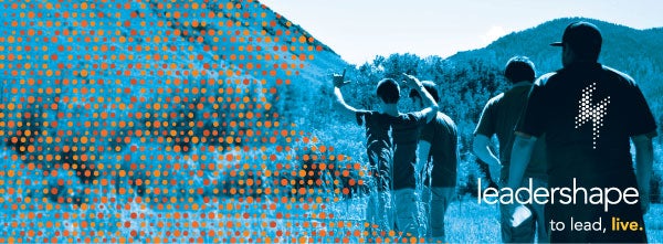 Students walking toward a mountain with text that reads Leadershape. To lead, Live.