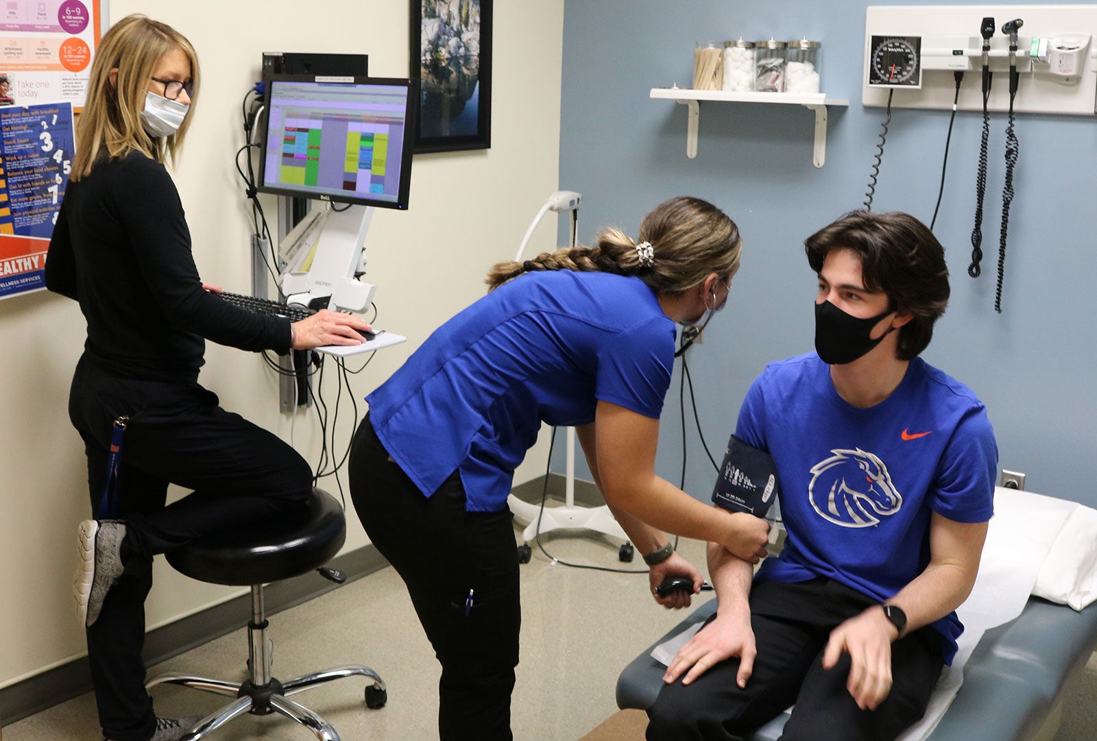 Nursing student Natalie Cacchillo takes patient’s blood pressure while supervised by Julee Huesby, Health Services nurse