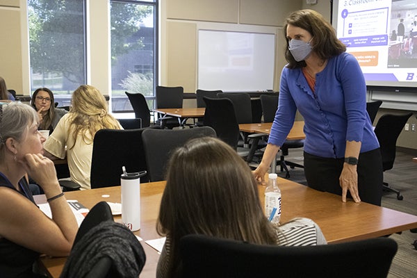 Associate Professor Michele Carney talks with teachers during the “Getting to the Root of Student Success” conference June 10.