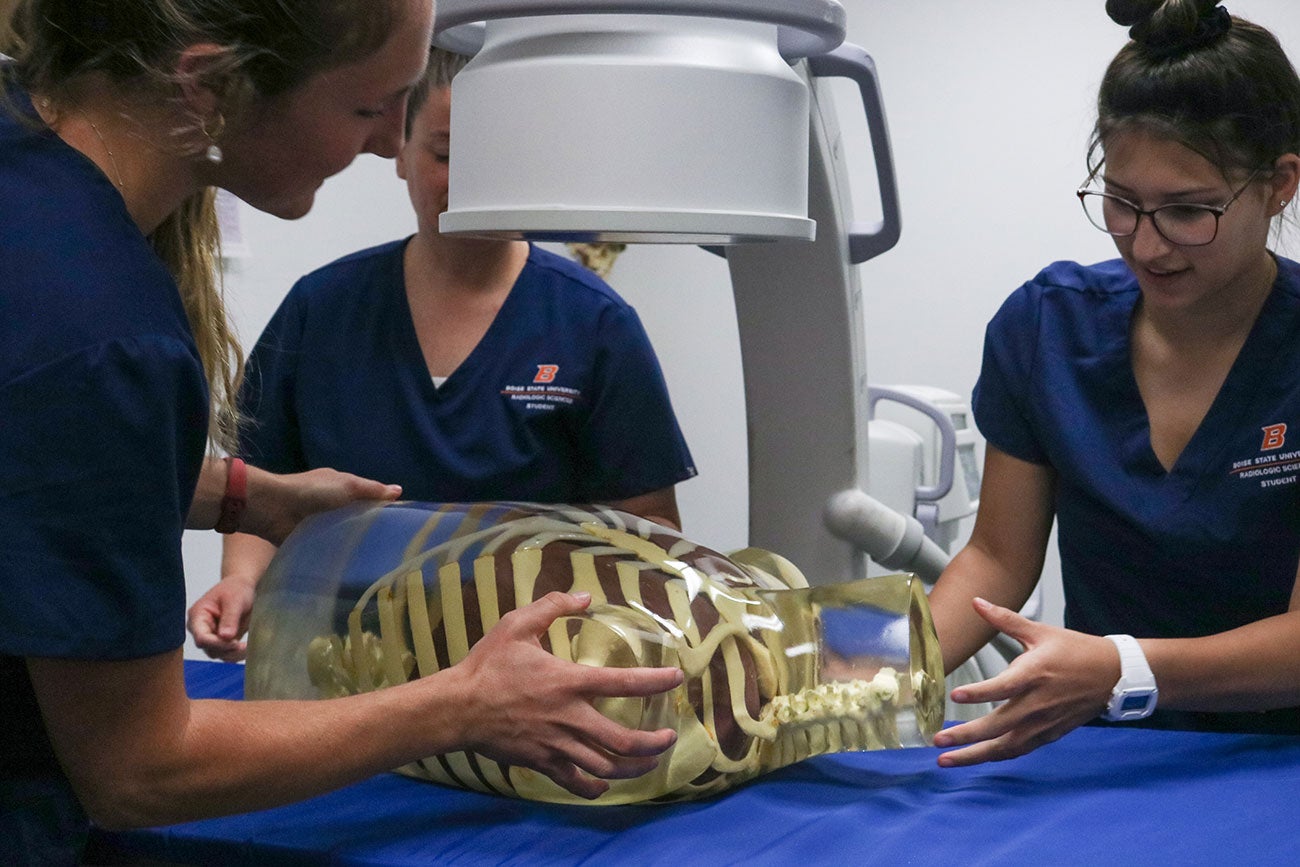 Radiologic Sciences students position the new C-arm on torso phantom