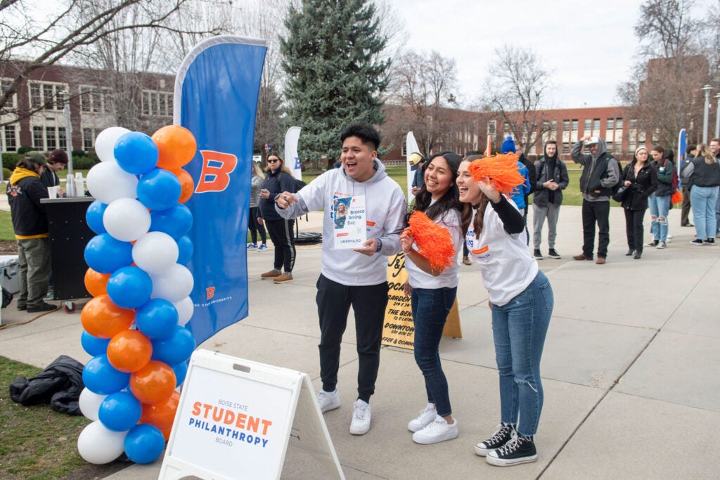 Boise State students with pom poms on the Quad during Bronco Giving Day