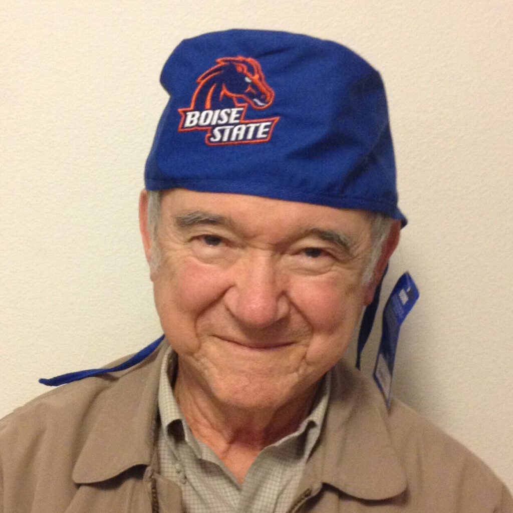 Dr. Ramon J. Jauregui. wearing a Boise State medical cap and khaki clothes, kindly smiles into the camera