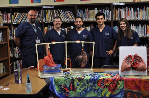 RadSciHealthFair Radiologic Sciences students with pig lungs demonstrating effects of smoking