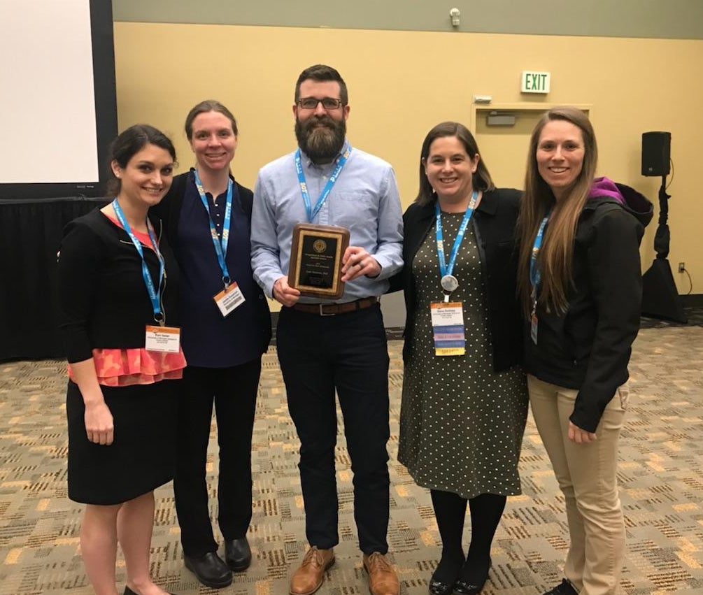 Luke Montrose, center, accepts his Best Manuscript Award.Luke Montrose, center, accepts his Best Manuscript Award.