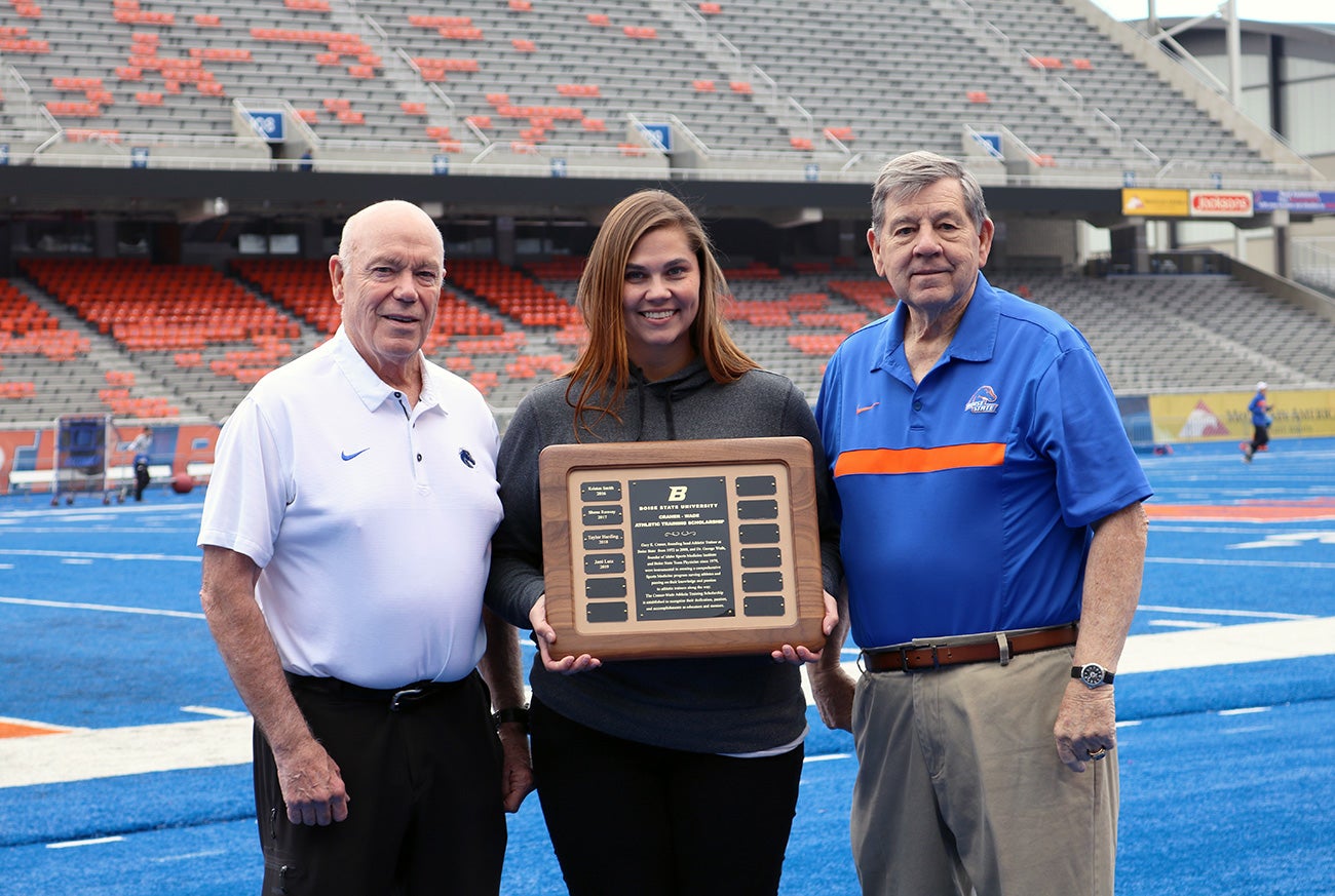 wade, a scholarship recipient, and Craner pose on the Blue field.