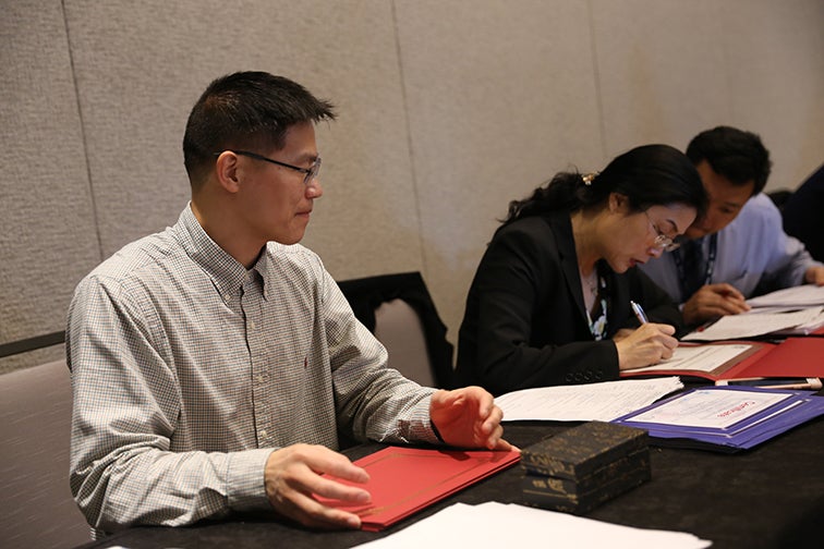 Gao reviewing papers with fellow researchers