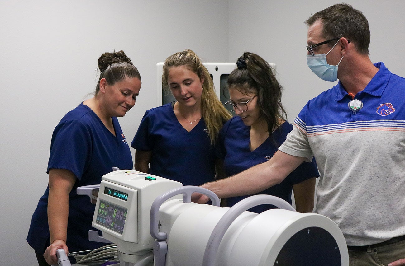 Radiologic Sciences faculty member Travis Armstrong, on right, demonstrate how to use the C-arm to three students