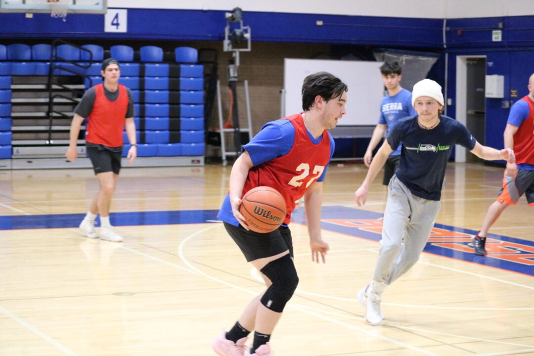 Aidan Roth dribbles the basketball away from his defender.