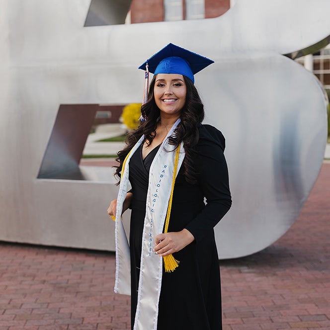 Jeleana Loa at the B plaza with her graduation cap and stole