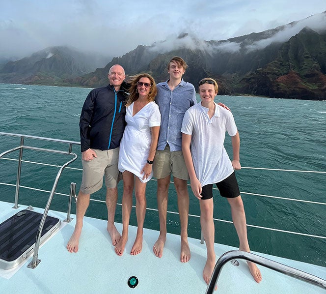 Joelle Powers and her husband and two sons on a boat in Kauai County, Hawaii
