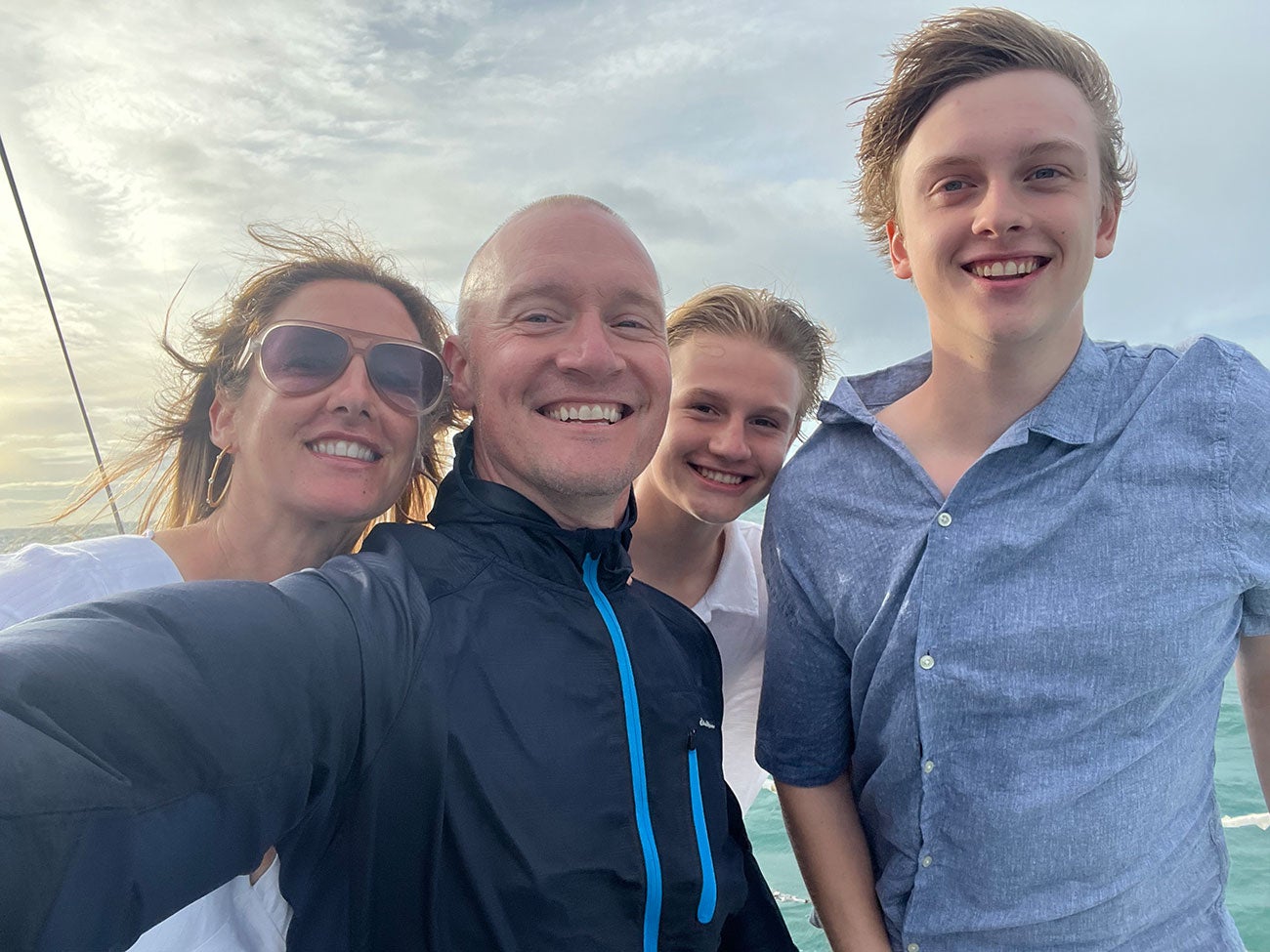 Dean Joelle Powers and her family with wind-swept hair in a family selfie