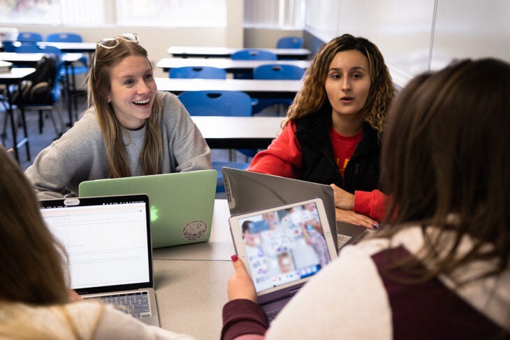 Anita Suljic works on a project with other students in a Master of Public Health class.