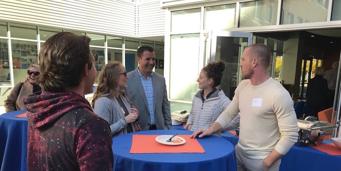 People gathered around a table talking to each other