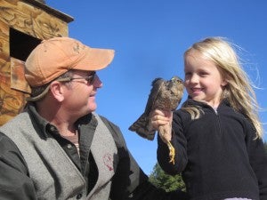Greg with his daughter looking at a Cooper's Hawk