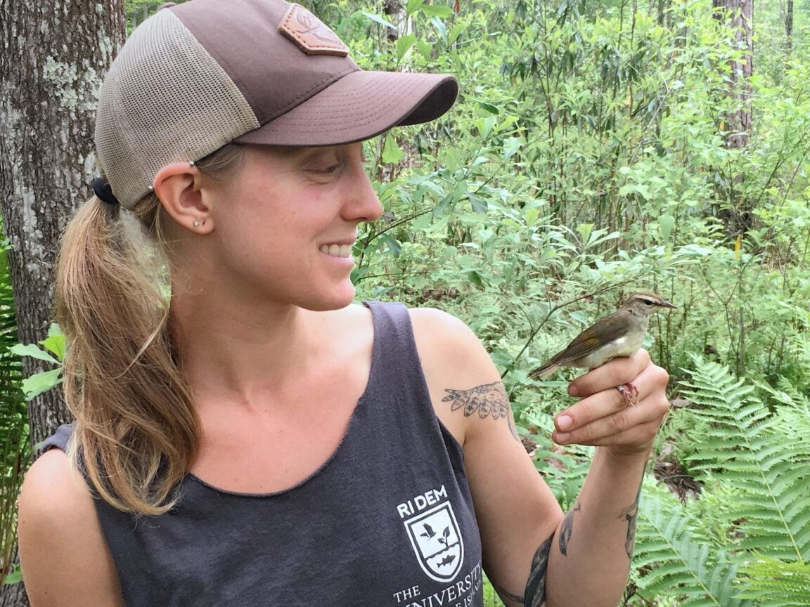 Lesley Howard holding a songbird