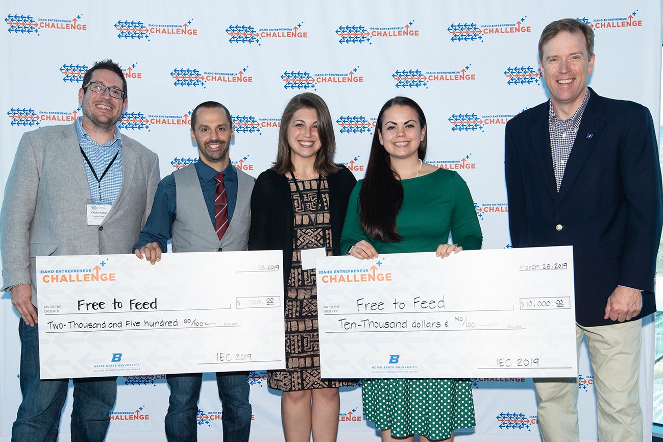 Five people pose as winners hold prize checks